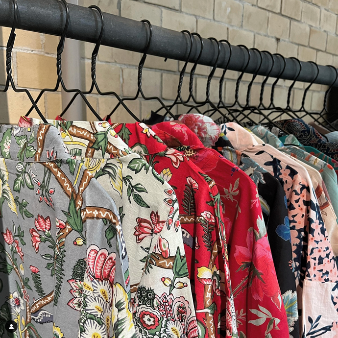 Colourful flower print kimonos on rack