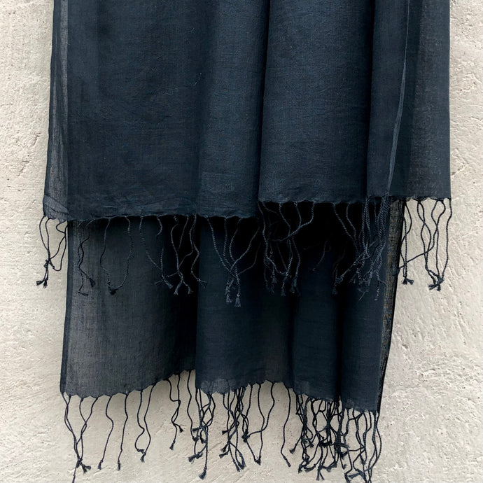 Close up of black handwoven cotton scarf with twisted fringes