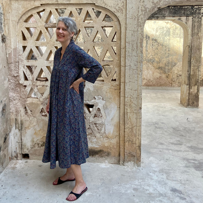 Model wearing kaftan dress with red and blue print in Amber Palace Jaipur India