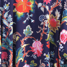Load image into Gallery viewer, Close-up of floral fabric with vibrant colors on a dark blue background