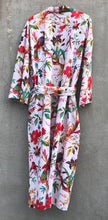 Load image into Gallery viewer, Back side of a floral and bird patterned robe on a concrete background