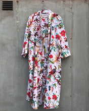 Load image into Gallery viewer, Floral patterned kimono robe hanging against a concrete wall