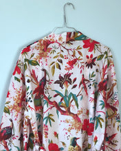 Load image into Gallery viewer, Floral and bird patterned robe on a hanger against a light blue wall