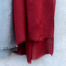 Load image into Gallery viewer, close up of red wool scarf, on a concrete wall background.