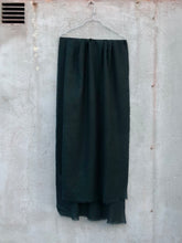 Load image into Gallery viewer, hanger with dark green wool scarf in front of concrete wall