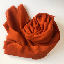 Load image into Gallery viewer, Rolle-up orange wool scarf on a white background