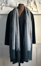 Load image into Gallery viewer, Mannequin wearing a gray gradient scarf with dark aqua blue border against a decorative wall.