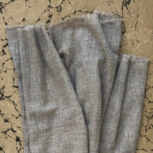 Load image into Gallery viewer, Raw cut fringes of stone beige wool scarf on marbled paper ground