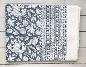 Folded tablecloth with indian flower print in blue and white