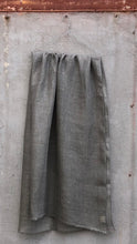 Load image into Gallery viewer, Grey linen scarf on hanger against a concrete wall